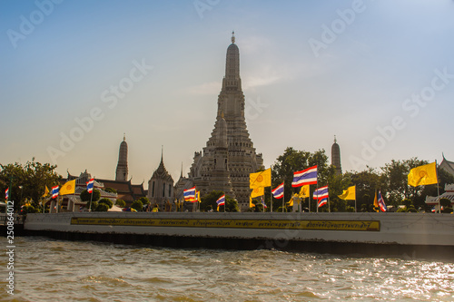 Tourist visited Wat Arun, the temple of dawn by Chao Phraya Express Boat and ferry for sightseeing tour in Bangkok along the Chao Phraya River. © kampwit