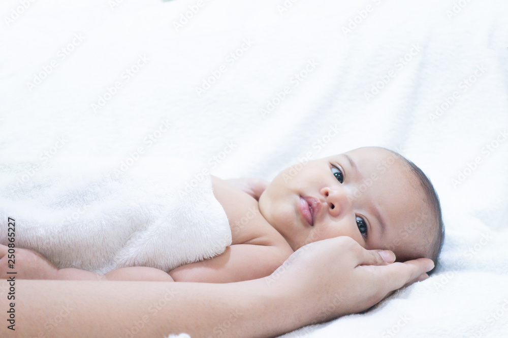 Mothers hand hold baby on white background. Asian baby is getting dry by her mother. Mothers hand hold baby on white background. Asian baby is getting dry by her mother.