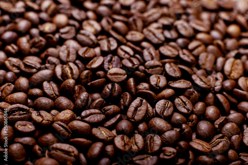 Aroma roasted coffee beans, brown banner background. Soft focus close up.
