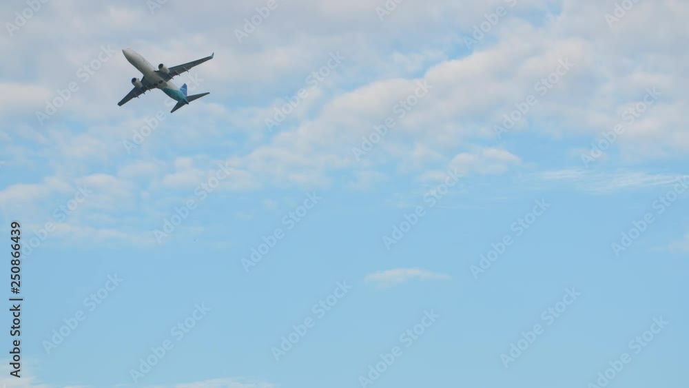 Passenger airplane takes off against the blue sky with clouds. Passenger airplane takes off against the blue sky with clouds.