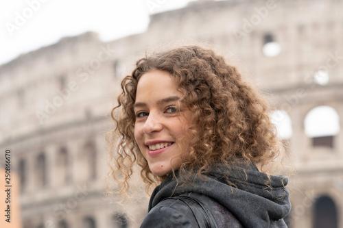 Photography Happy young female tourist in front of the Colosseum, or Coliseum in Rome, Italy