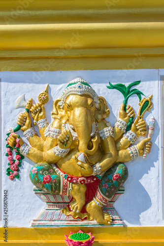 Colorful Ganesha Hindu god avatar images in stucco low relief white wall at the public Wat Samarn temple, Chachoengsao, Thailand. Ganesha also known as Ganapati, Vinayaka, Pillaiyar and Binayak. photo