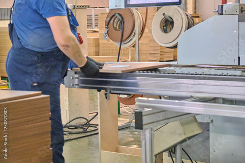 Laying chipboard for processing and production of furniture in a woodworking enterprise. photo