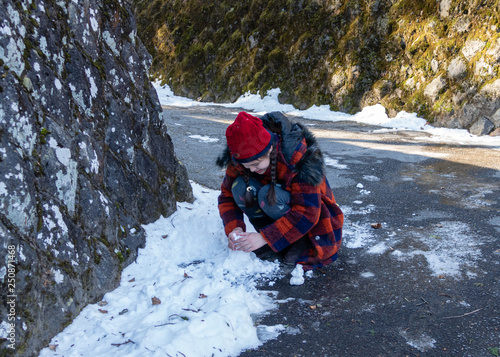 Tween girl making snowball