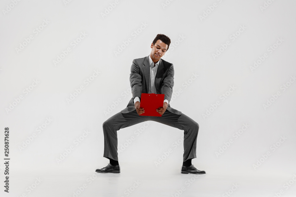 Happy businessman dancing in motion isolated on white studio background. Flexibility and grace in business. Human emotions concept. Office, success, professional, happiness, expression concepts Happy businessman dancing in motion isolated on white studio background. Flexibility and grace in business. Human emotions concept. Office, success, professional, happiness, expression concepts