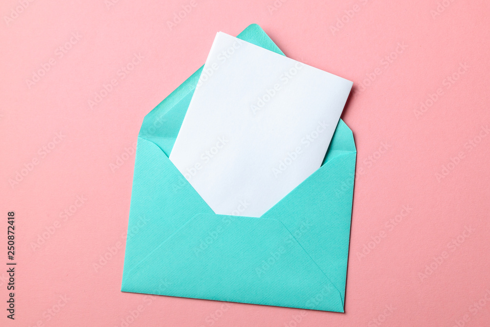Green envelope and blank letter on pink background Green envelope and blank letter on pink background