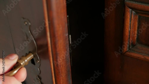opening old, mysterious wardrobe, dodging the door, old key