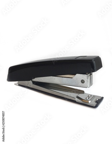 Stapler, or stapler on a white background - a device for fastening sheets of paper with metal clips.