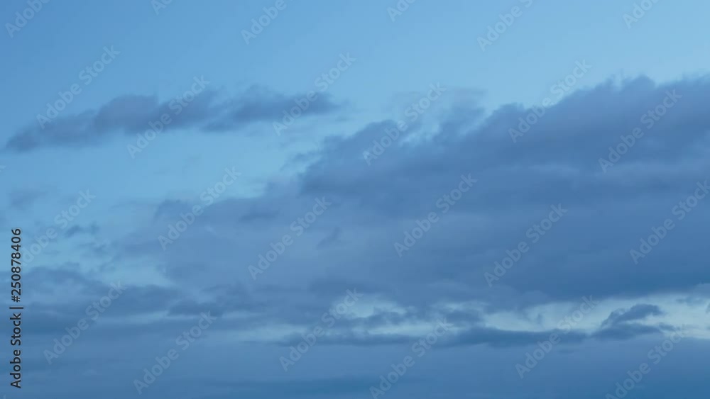 Russia, time lapse. Formation and rapid movement of white clouds of different shapes in the blue sky in late spring at sunset. Russia, time lapse. Formation and rapid movement of white clouds of different shapes in the blue sky in late spring at sunset.