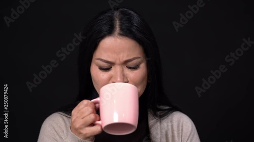 Lovely Asian dislikes the taste of the coffee