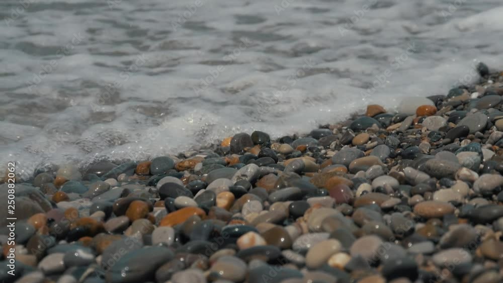 Silky waves on the sea pebbles. Shingle beach Silky waves on the sea pebbles. Shingle beach