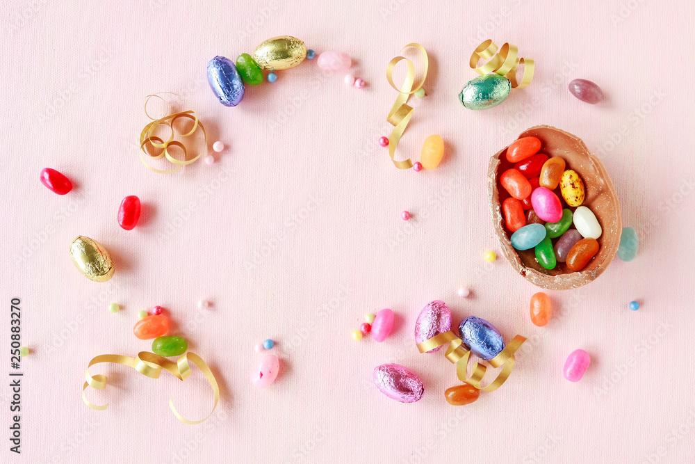 Chocolate Easter eggs and other sweets on pink background. Chocolate Easter eggs and other sweets on pink background.