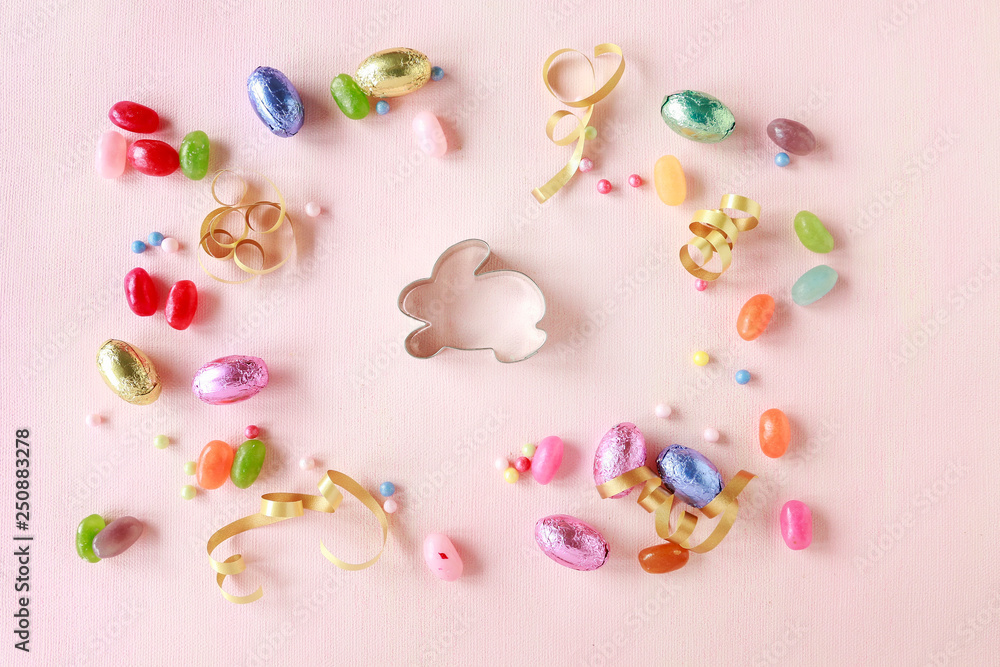 Chocolate Easter eggs and other sweets on pink background. Chocolate Easter eggs and other sweets on pink background.