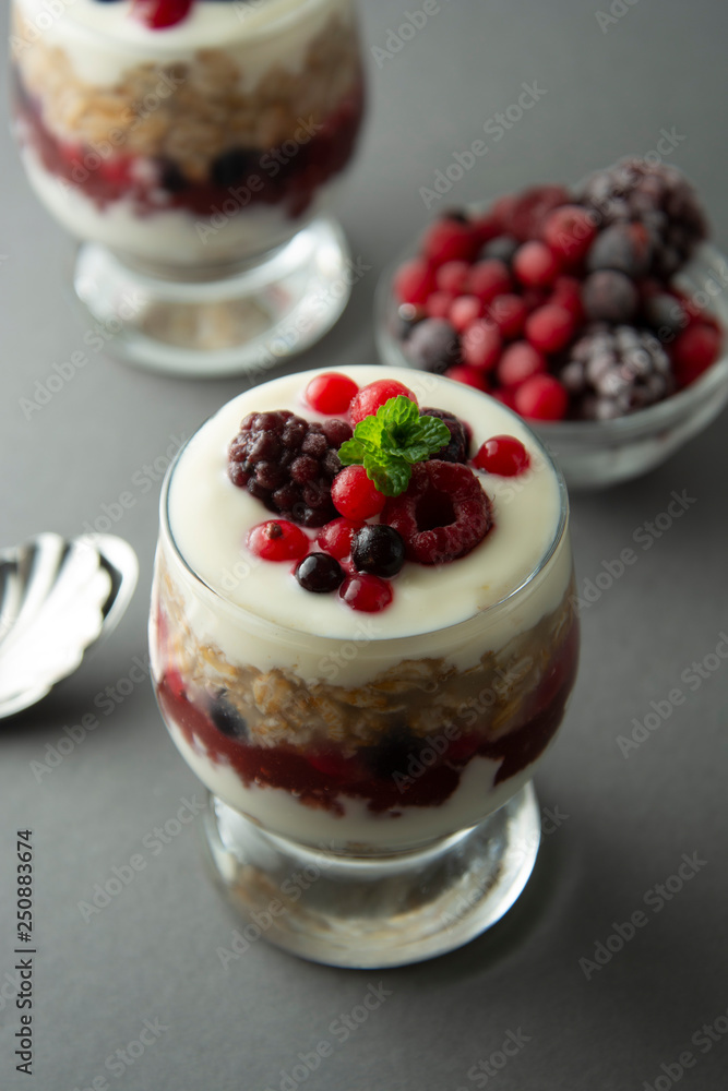 Overnight oats, muesli with berries. Healthy breakfast in glass over grey background. Tasty oatmeals with yogurt. Overnight oats, muesli with berries. Healthy breakfast in glass over grey background. Tasty oatmeals with yogurt.