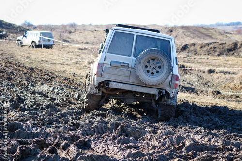 Ukrainian offroad competition in the city of Kamyanets Podilsky. Swamp and mud on cars. Produce large puddles © Yaroslav