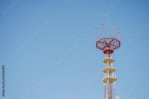Technology communication tower ,TV Antenna, telephone connection at blue sky background.