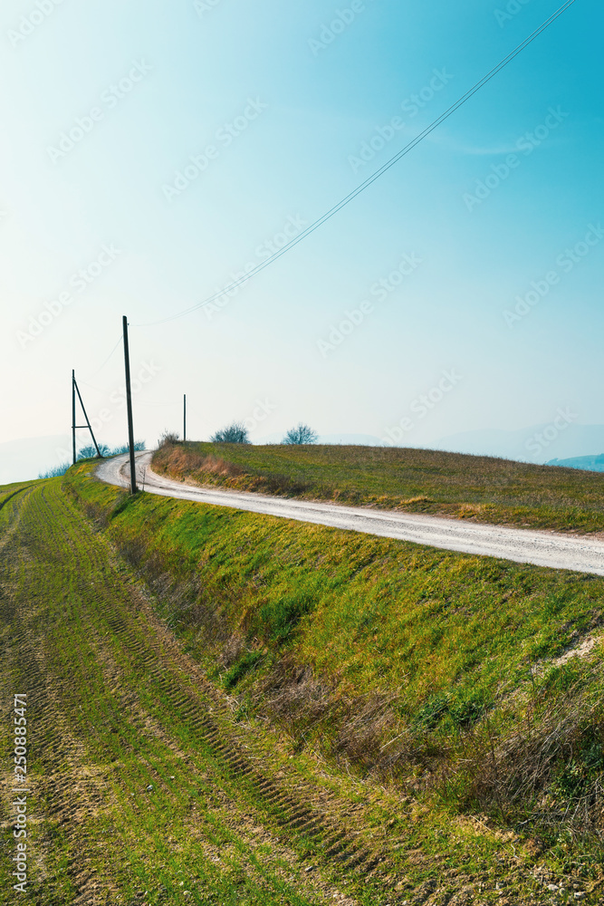 Natural background, landscape with fields and white country road Natural background, landscape with fields and white country road