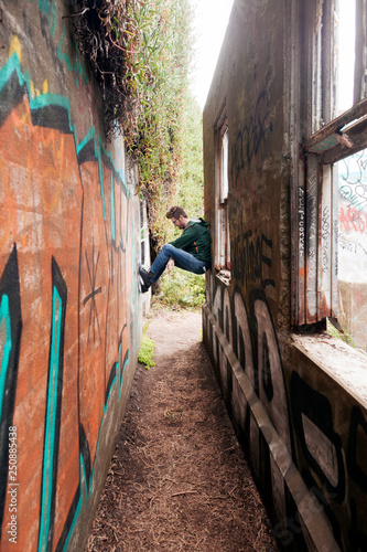 Wallpaper Mural Mid adult man sitting and leaning against walls  Torontodigital.ca
