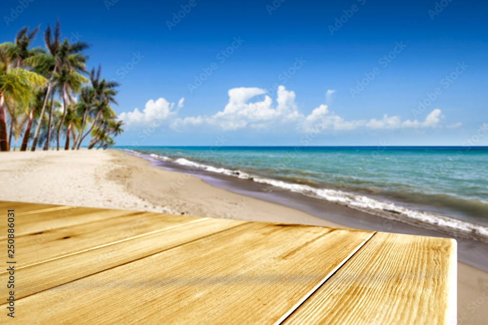 Fototapeta premium Wooden desk of free space and summer time on beach. 
