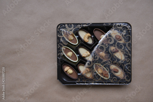 box of chocolates on kraft paper background, festive food, sweet romantic gift, confectionery