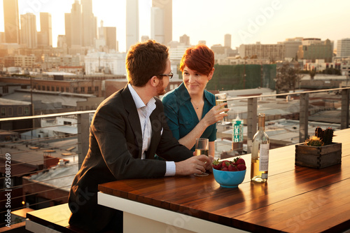 Couple drinking wine on porch at sunset  photo