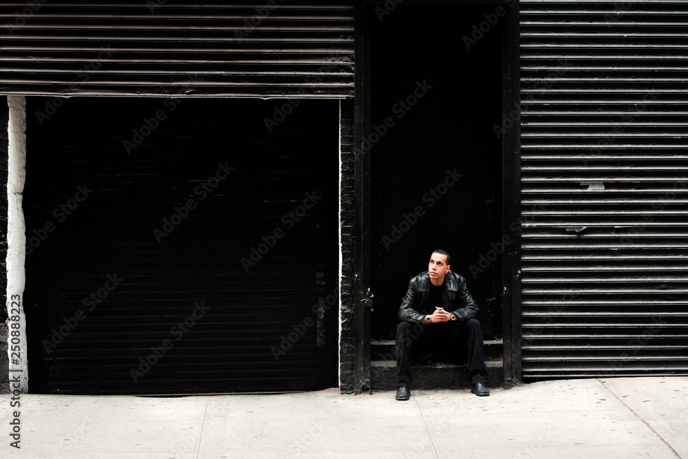 Man Sitting on Urban Street Man Sitting on Urban Street