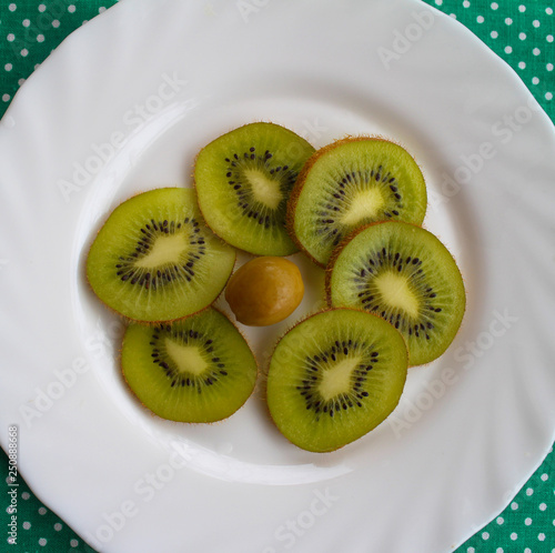 pieces of kiwi on the white plate photo