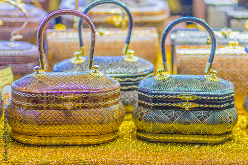 Beautiful lady handbags and basketry that made from Lygodium (climbing fern), or "Yan lipao" in Thai, the famous product from Southern Thailand for sale at night market, Bangkok. Selective focus
