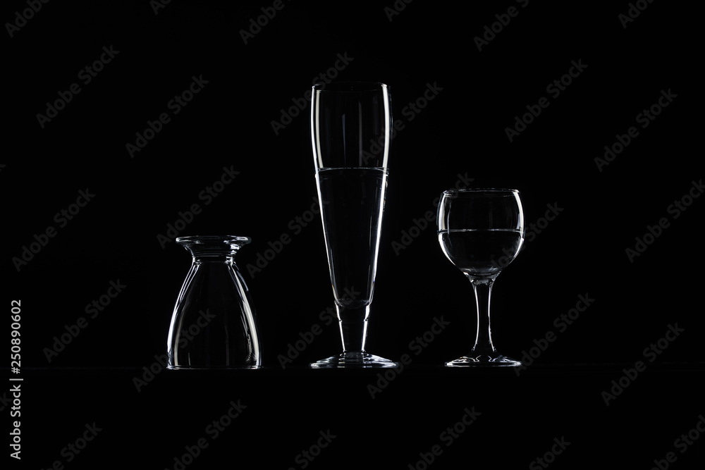 set of transparent glasses on black background set of transparent glasses on black background