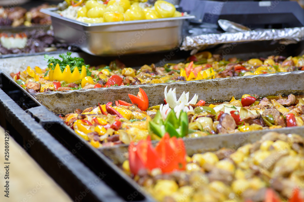 Traditional Hungarian pig slaughter dishes. Street food festival, food service. Fried pork with vegetables