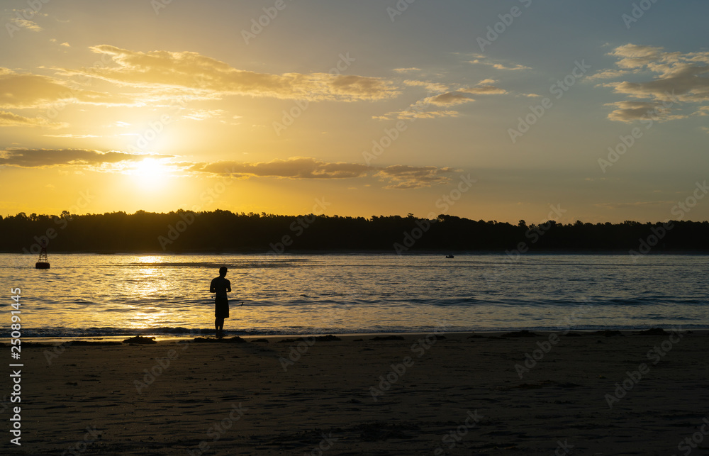 Distant silhouette of fisherman casting into Tauranga Harbour entrance, Distant silhouette of fisherman casting into Tauranga Harbour entrance,