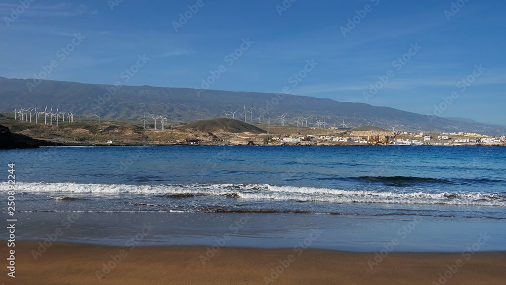 Empty and clean beautiful beach with inland views of the south-eastern coast of the island, at Playa Poris de Abona, Tenerife, Canary Islands, Spain