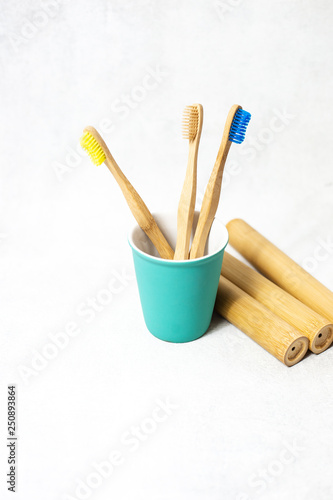 A family set of wooden bamboo toothbrushes on white background