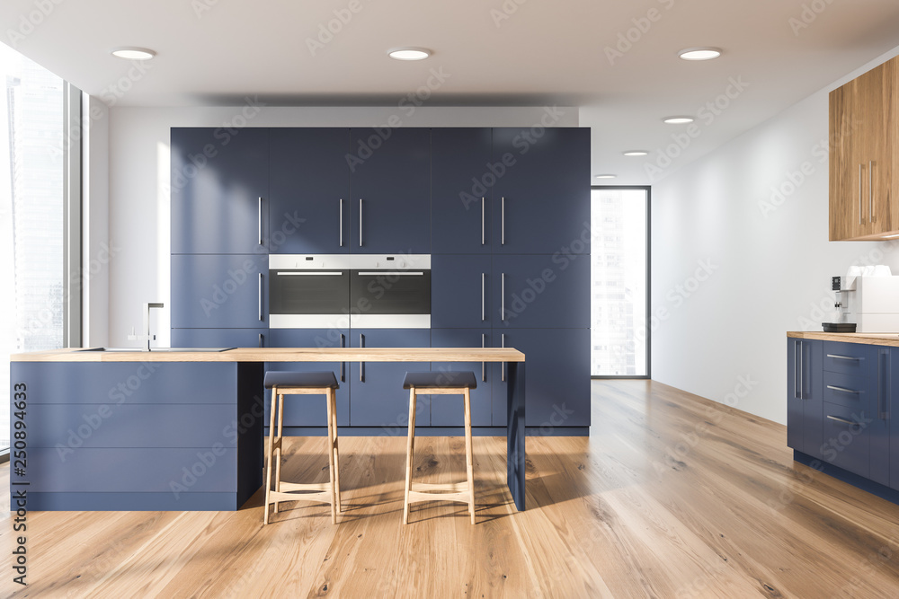 Fototapeta premium White kitchen with blue cupboard and bar