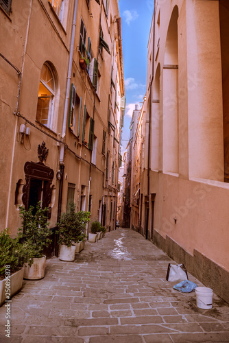 Fototapeta Naklejka Na Ścianę i Meble -  Narrow street in Genova city and the blue sky