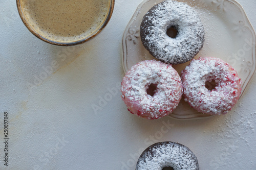 Fresh coffee and colorful donuts on white marble background, sweet breackfast, cappuccino with pastry