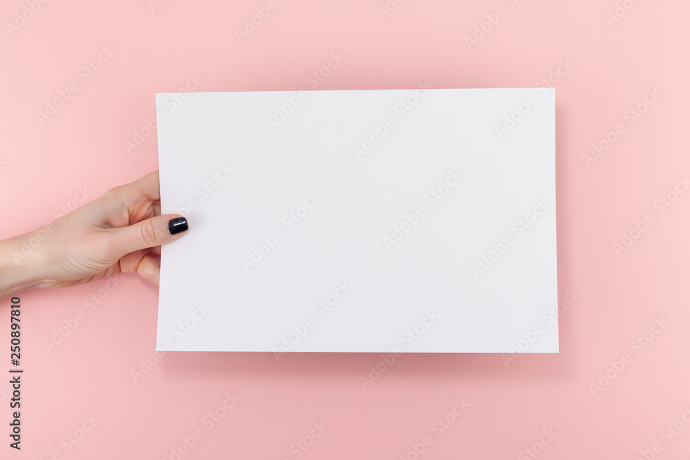 Woman hands with blank A4 paper sheet mockup Woman hands with blank A4 paper sheet mockup
