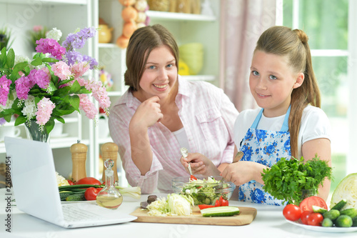 Portrait of funny girls preparing fresh salad