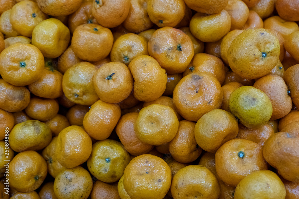 Spoiled tangerines. Background of bad citrus in the store. Rotting fruit goods at the grocery store. Spoiled tangerines. Background of bad citrus in the store. Rotting fruit goods at the grocery store.