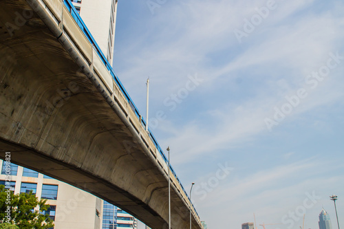Sky train bridge structure with beam and girder under blue sky background. Railway and tollway in the city with blue sky background. Public area in Bangkok, Thailand. © kampwit