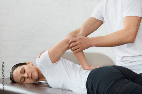 Fotografija Female patient doing physical exercises with physiotherapist