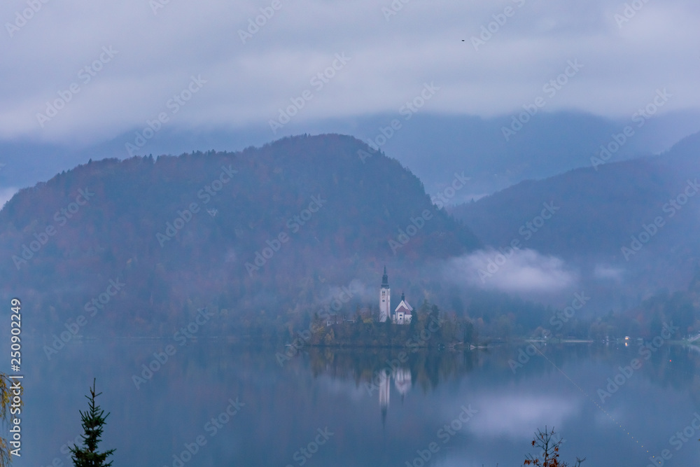 Beautiful autumn dusk landscape around Lake Bled with Pilgrimage Church of the Assumption of Maria