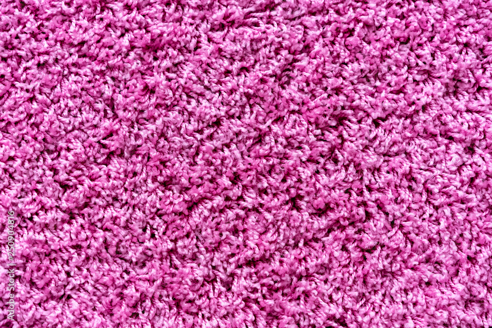 Fototapeta premium Тexture of a magenta carpet with a large nap.