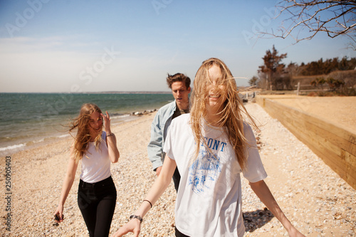 Young people walking on beach 