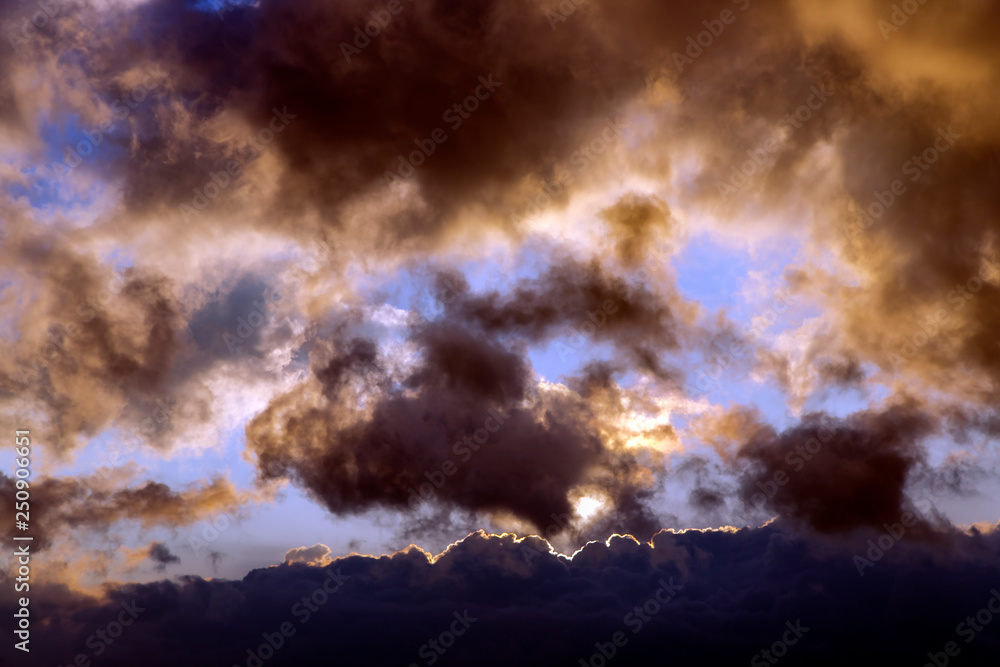 Sunrise in the Dongchuan mountains  - dark storm clouds against blue sky