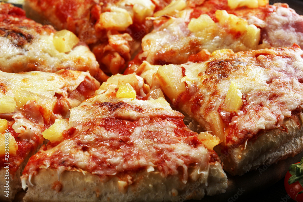 Delicious pizza with pineapple, ham slice, bacon slice, mozzarella cheese, pizza sauce on rustic background for fast food and ready to eat concept Delicious pizza with pineapple, ham slice, bacon slice, mozzarella cheese, pizza sauce on rustic background for fast food and ready to eat concept