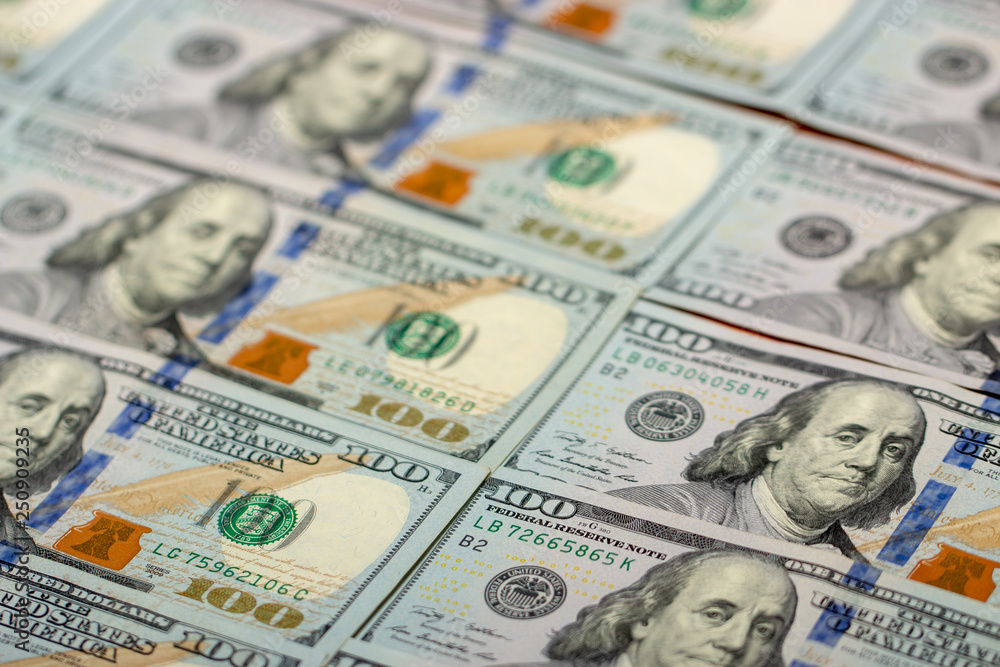 Blurred background full of 100 us dollars. Business and finance. selective focus. Blurred background full of 100 us dollars. Business and finance. selective focus.
