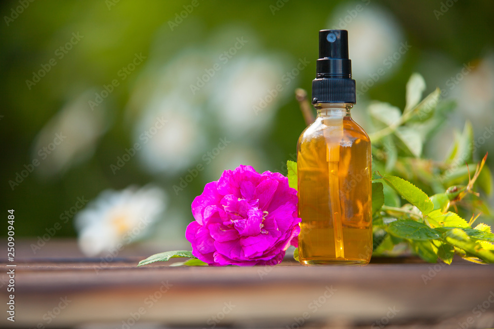 Essence of flowers on table in beautiful glass jar Essence of flowers on table in beautiful glass jar