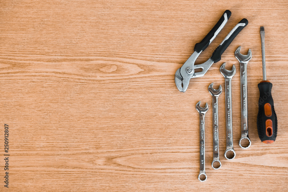 Wrench and screwdriver on wooden background Wrench and screwdriver on wooden background