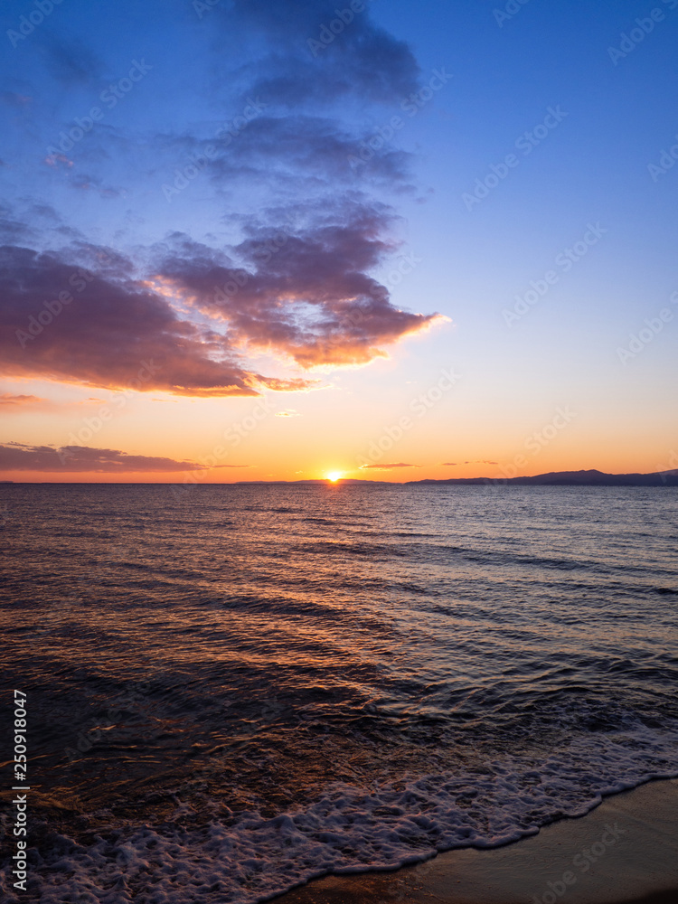 Sun is setting on the beach in Kavala, Greece
